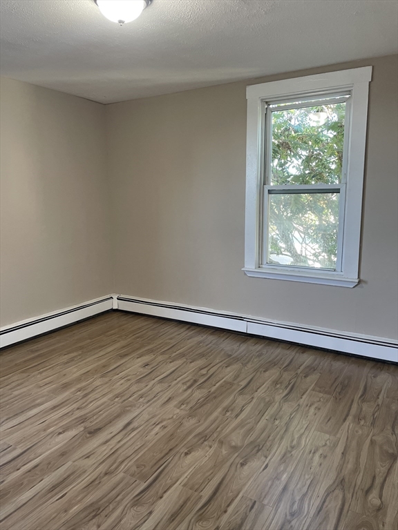 18 Lawton Avenue, Unit 3 Lynn, MA 01902 - Photo 12 of 24 a big room with wooden floor and windows