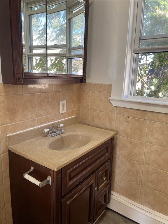 18 Lawton Avenue, Unit 3 Lynn, MA 01902 - Photo 15 of 24 a bathroom with a sink and a window