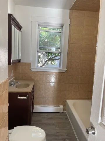 a bathroom with a sink a toilet and bathtub