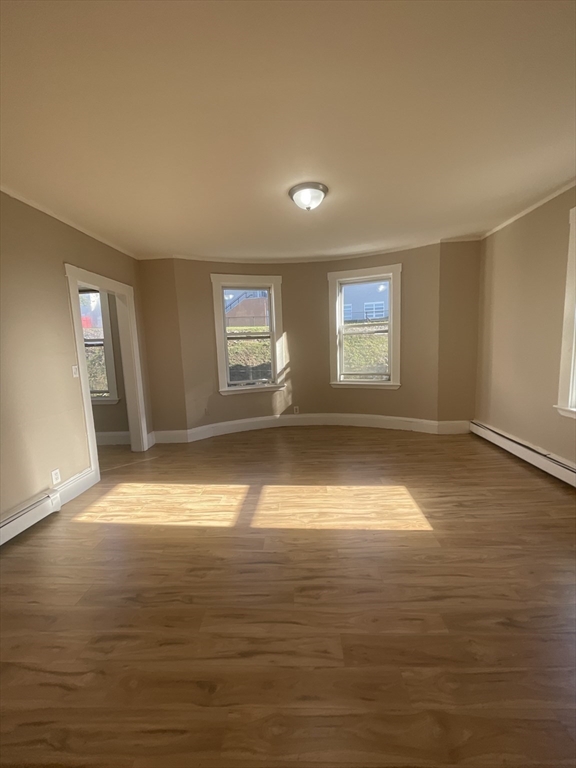 18 Lawton Avenue, Unit 3 Lynn, MA 01902 - Photo 2 of 24 wooden floor in an empty room with a window