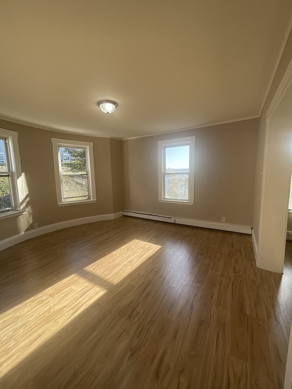 18 Lawton Avenue, Unit 3 Lynn, MA 01902 - Photo 4 of 24 a view of empty room with window and wooden floor
