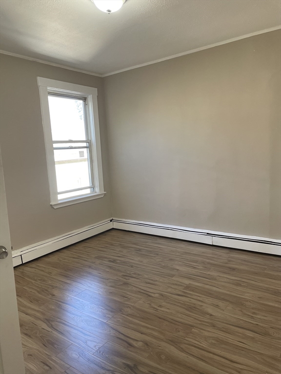 18 Lawton Avenue, Unit 3 Lynn, MA 01902 - Photo 8 of 24 a view of an empty room with wooden floor and a window