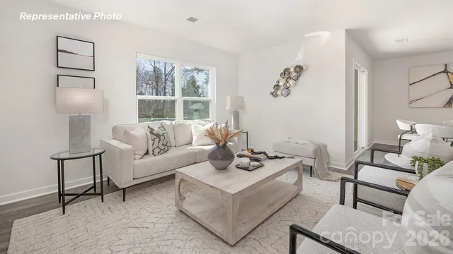 a living room with furniture a lamp and a window