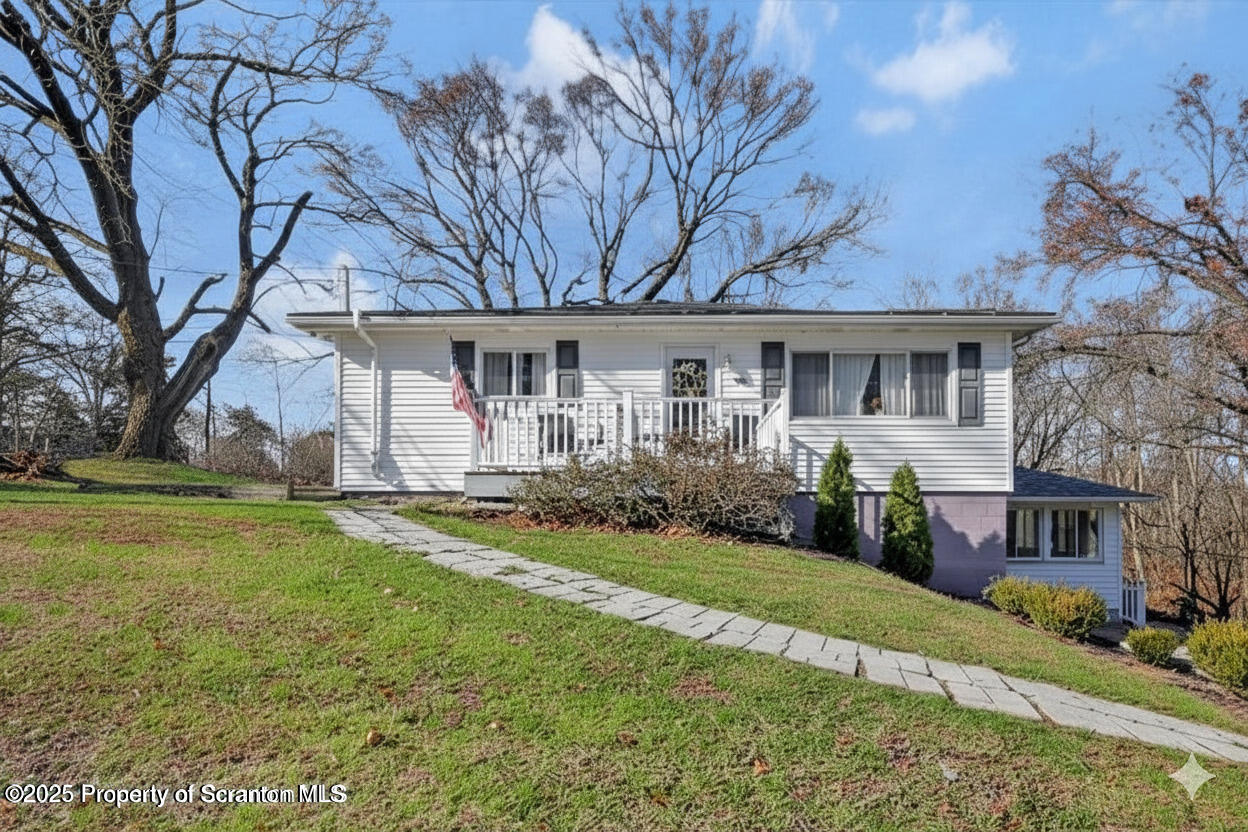 a view of house with yard and green space
