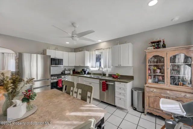 a kitchen that has a lot of cabinets a sink and a stove in it