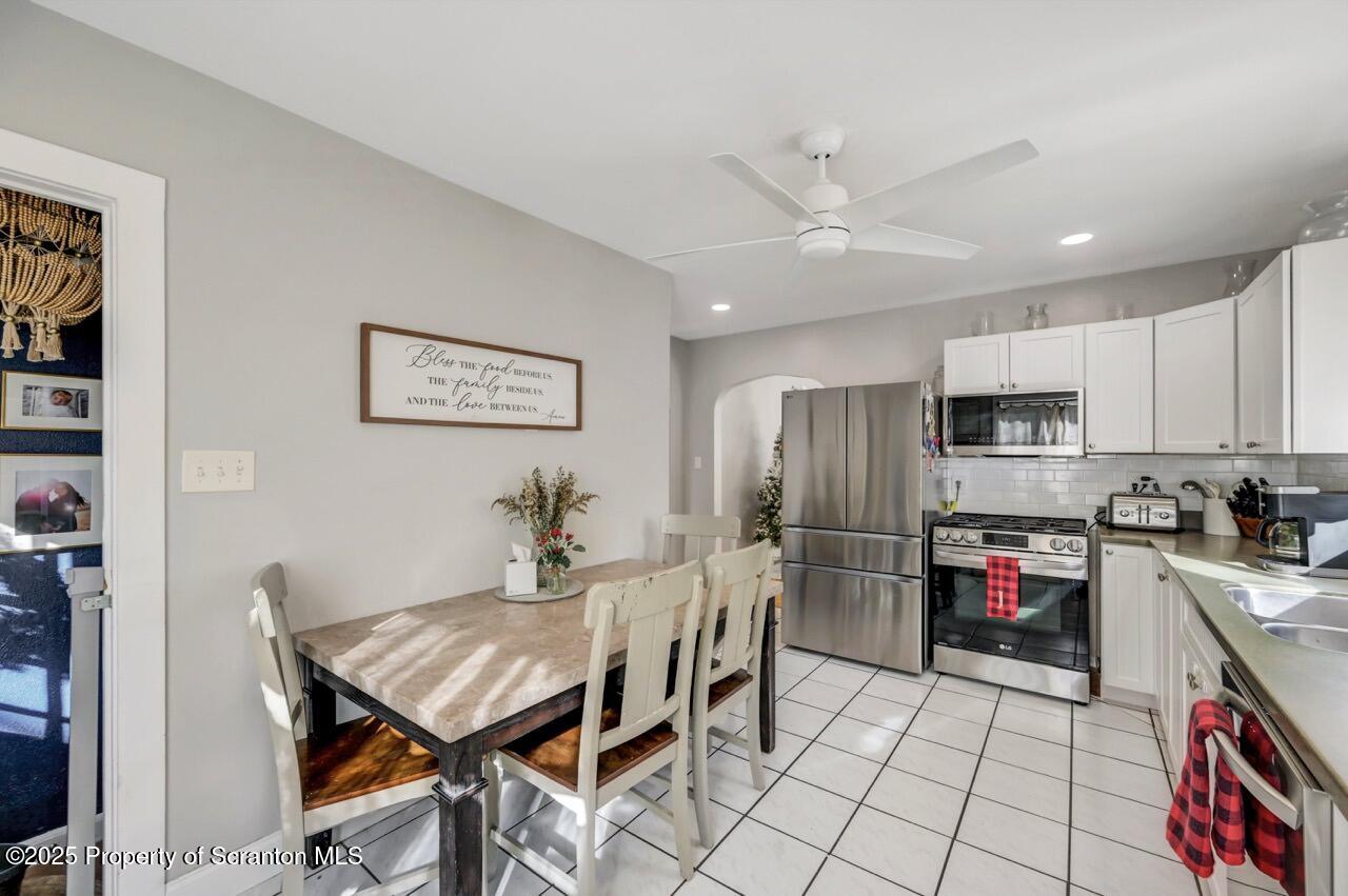 101 Miller Road Clarks Summit, PA 18411 - Photo 13 of 51 a kitchen with stainless steel appliances granite countertop a refrigerator and a stove top oven