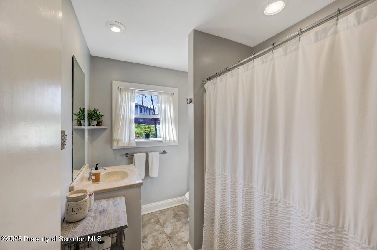101 Miller Road Clarks Summit, PA 18411 - Photo 16 of 51 a bathroom with a sink a bathtub and a window