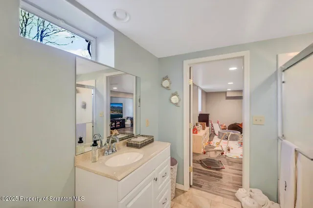 a bathroom with a sink vanity and mirror
