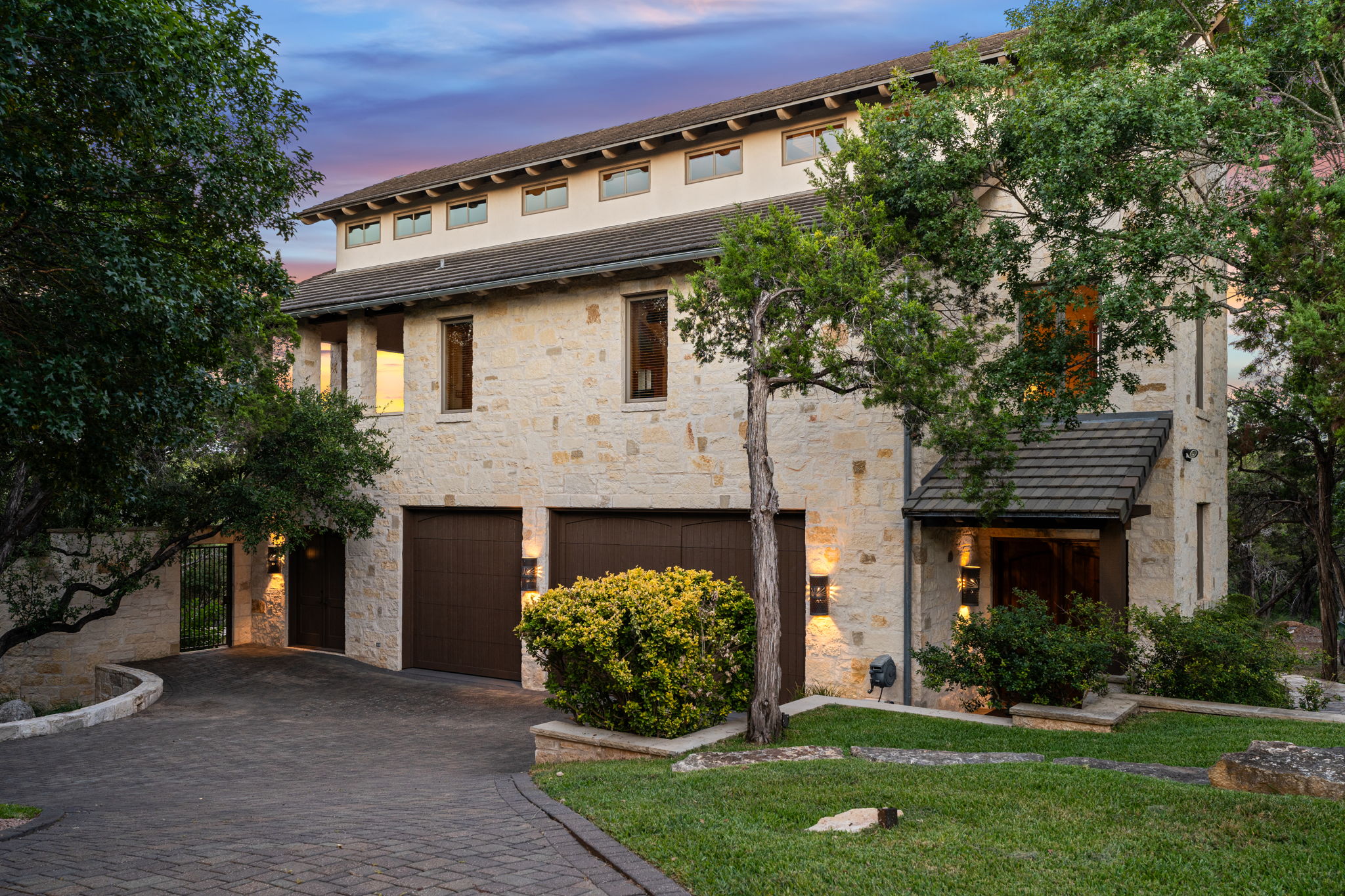 11949 Overlook Pass Austin, TX 78738 - Photo 34 of 40 View of front of home with stone siding, a tiled roof, an attached garage, decorative driveway, and a front yard