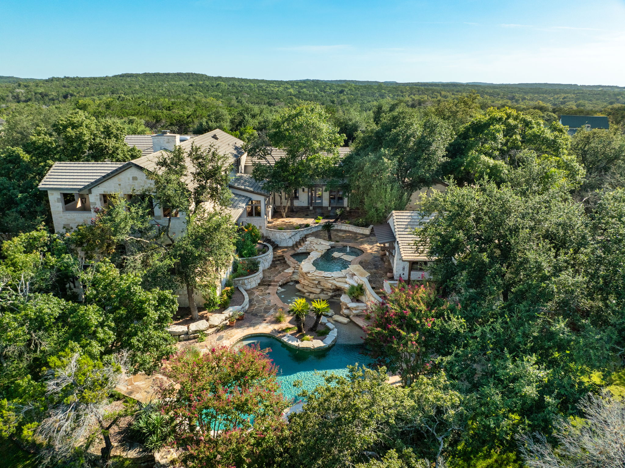 11949 Overlook Pass Austin, TX 78738 - Photo 4 of 40 Aerial view of property and surrounding area featuring a heavily wooded area