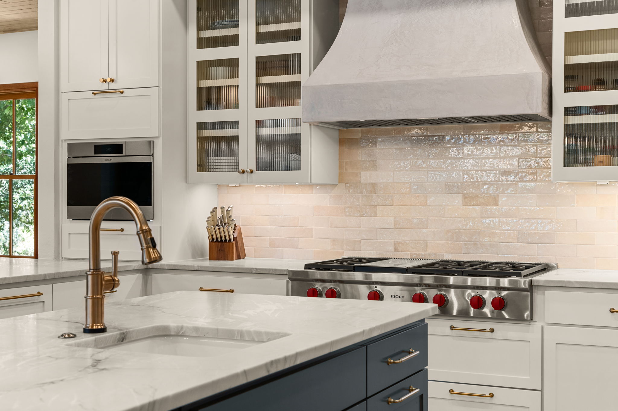 11949 Overlook Pass Austin, TX 78738 - Photo 10 of 40 Kitchen with custom range hood, a sink, stainless steel appliances, and white cabinets