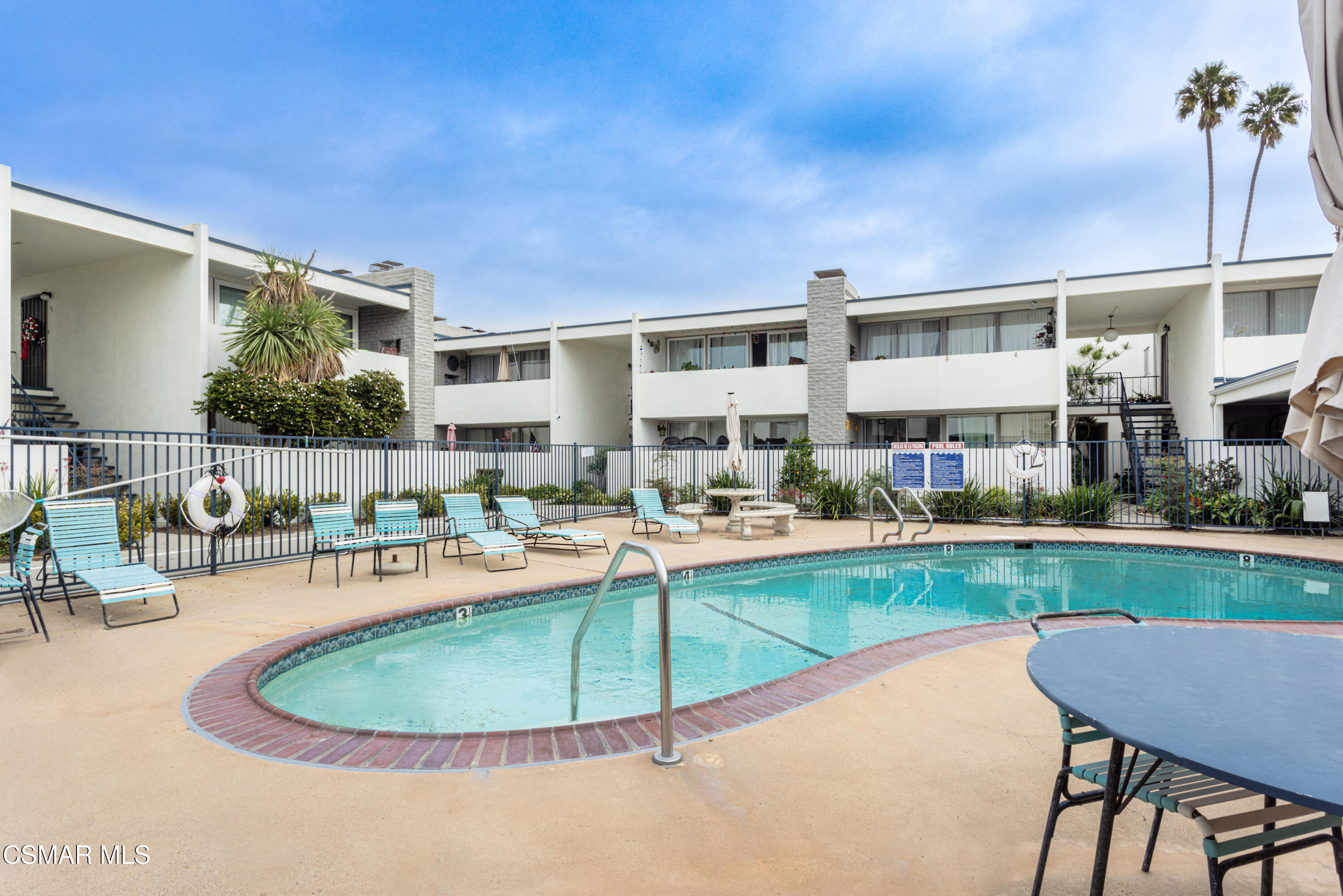 1337 Edgewood Way, Unit 37 Oxnard, CA 93030 - Photo 13 of 13 a view of a swimming pool and chairs in patio