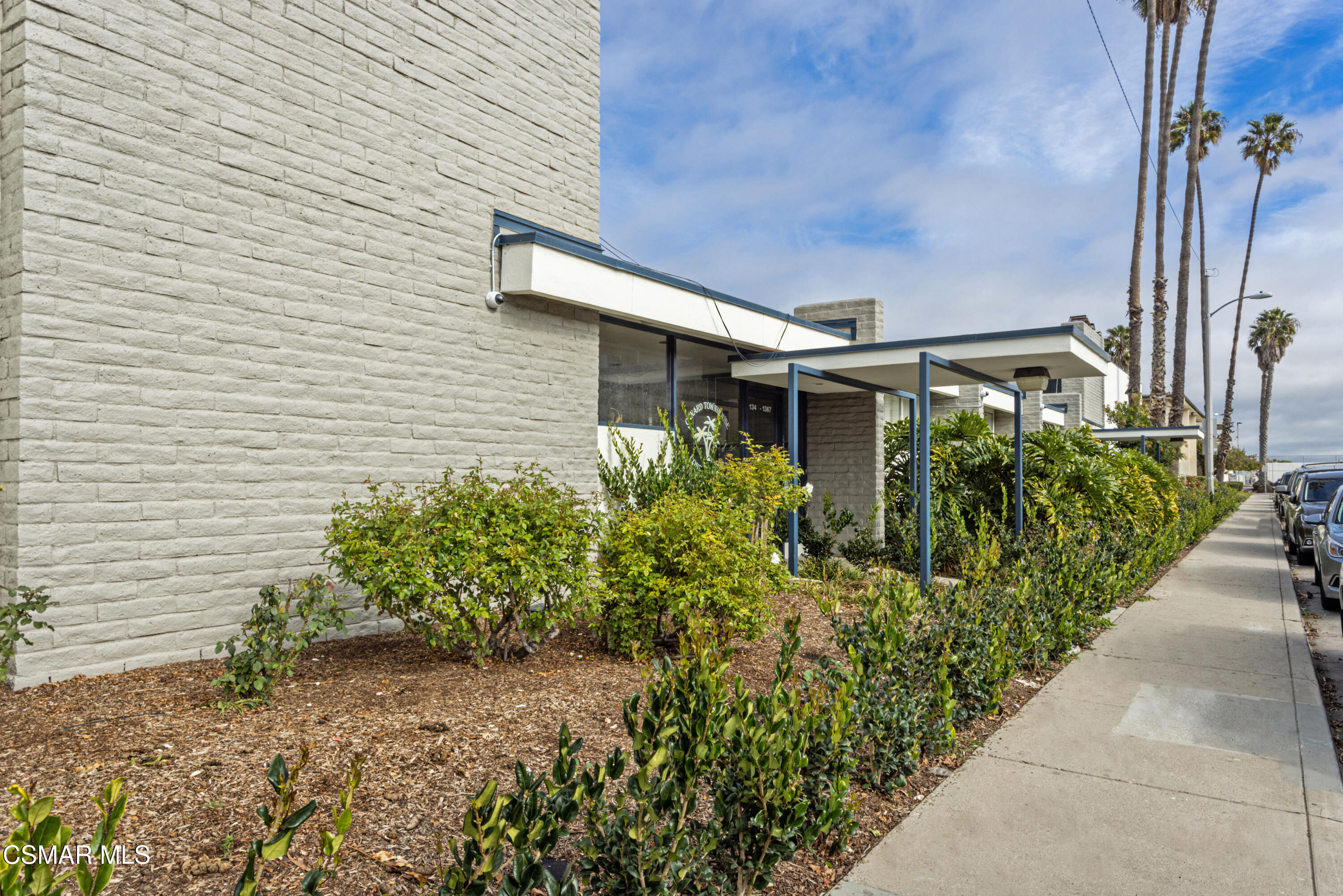 1337 Edgewood Way, Unit 37 Oxnard, CA 93030 - Photo 2 of 13 a front view of a house with garden