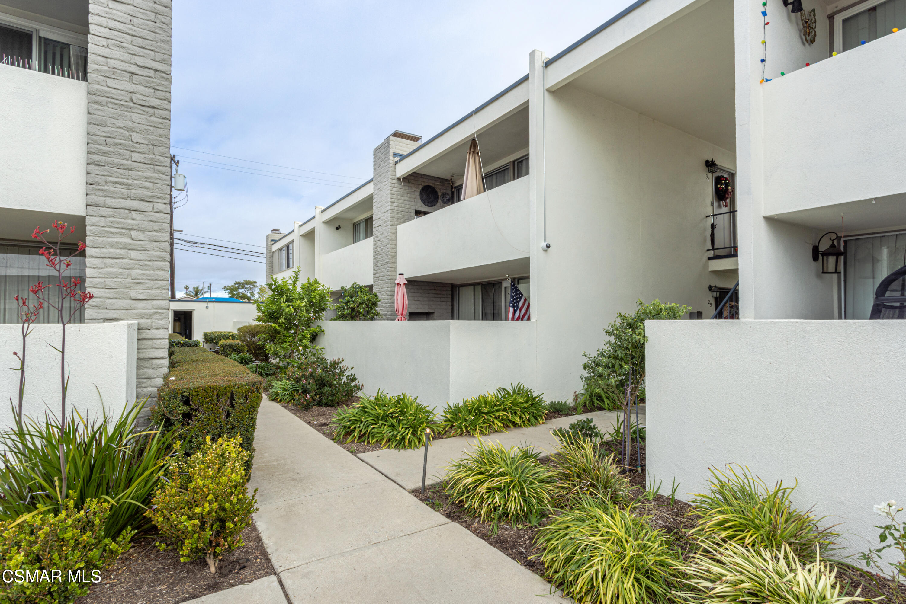 1337 Edgewood Way, Unit 37 Oxnard, CA 93030 - Photo 3 of 13 a front view of a house with a yard