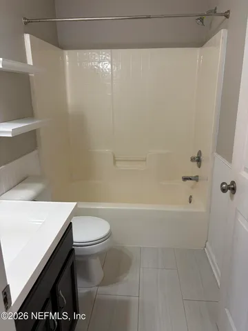 a bathroom with a bathtub and a toilet
