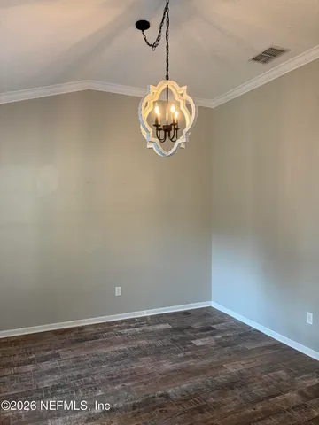 a view of a room with wooden floor and fan