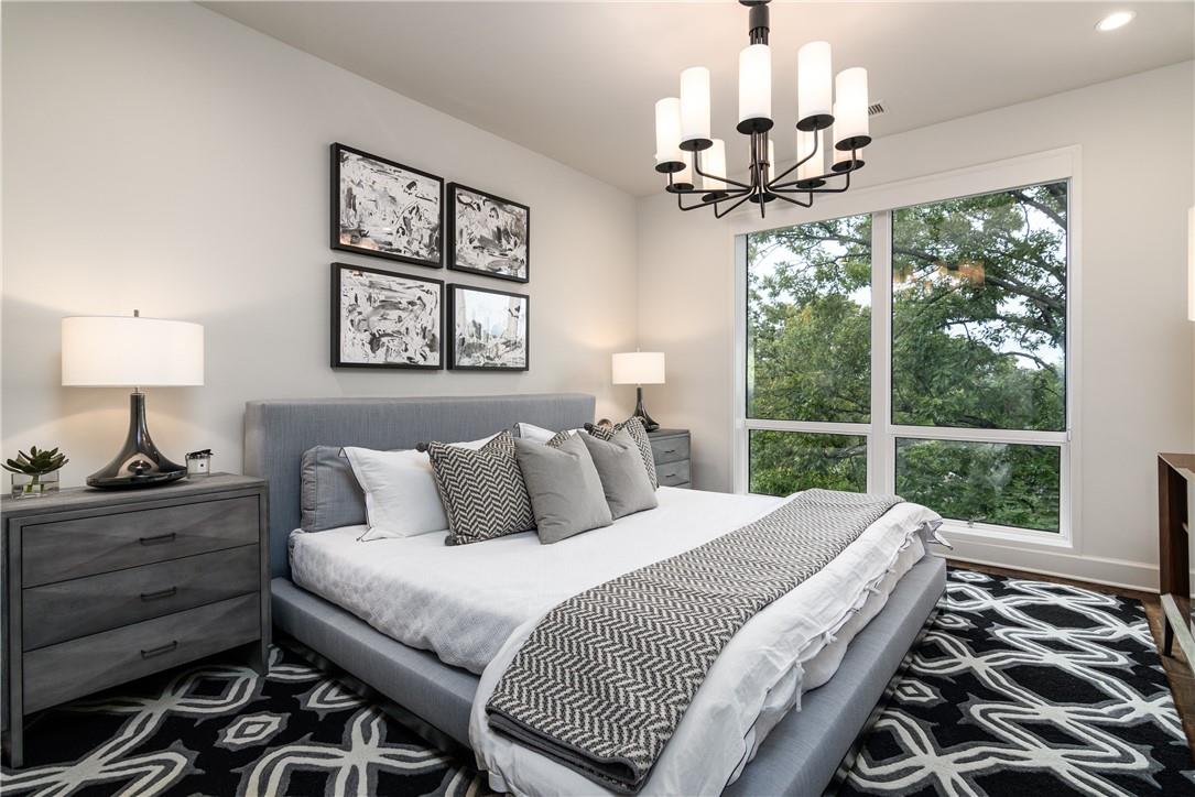 866 Cherokee Road Charlotte, NC 28207 - Photo 19 of 35 a bedroom with a large bed and a chandelier
