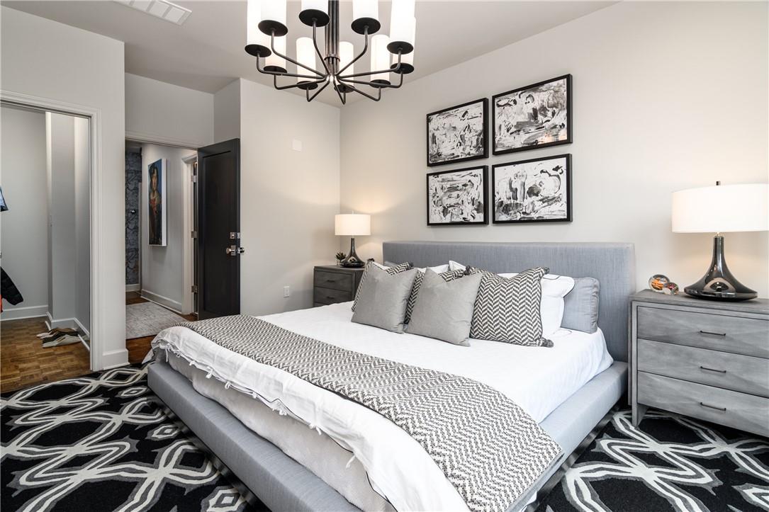 866 Cherokee Road Charlotte, NC 28207 - Photo 20 of 35 a bedroom with a bed and a chandelier