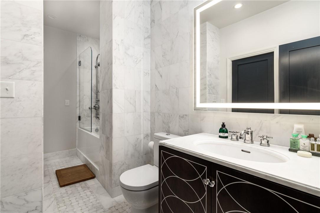 866 Cherokee Road Charlotte, NC 28207 - Photo 24 of 35 a bathroom with a sink a toilet a mirror and shower