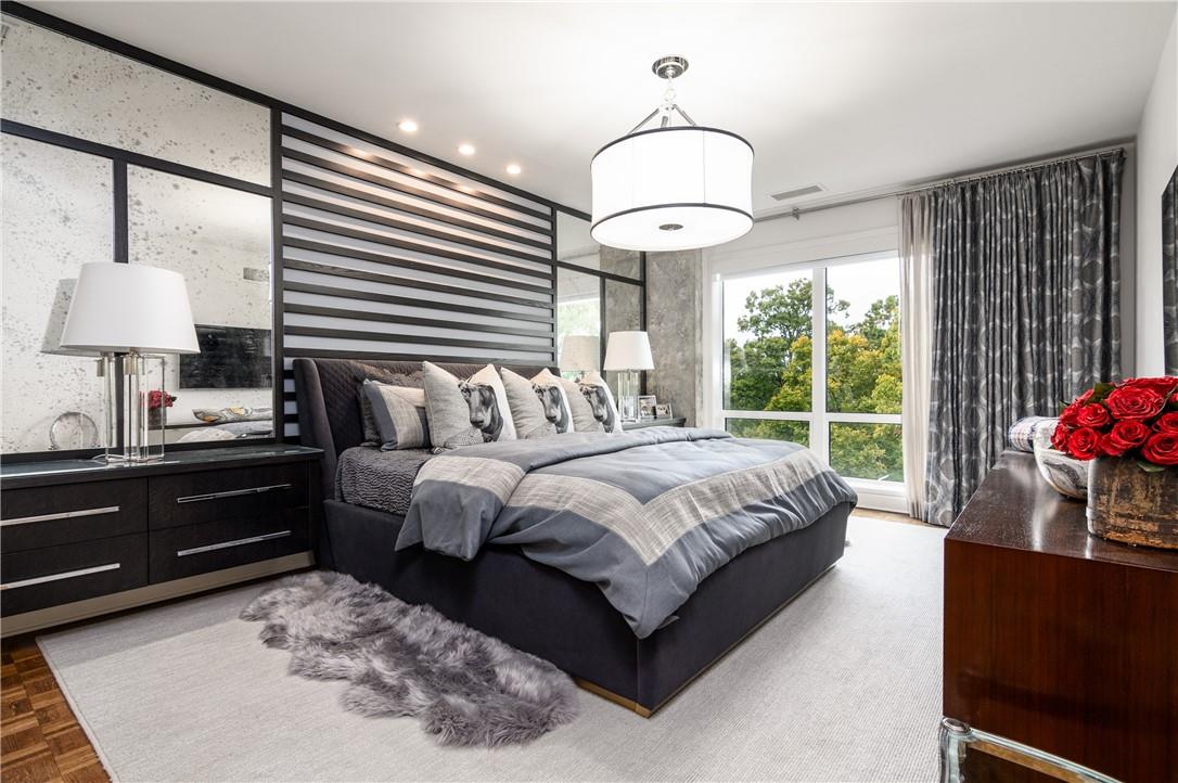 866 Cherokee Road Charlotte, NC 28207 - Photo 26 of 35 a bedroom with bed and a chandelier