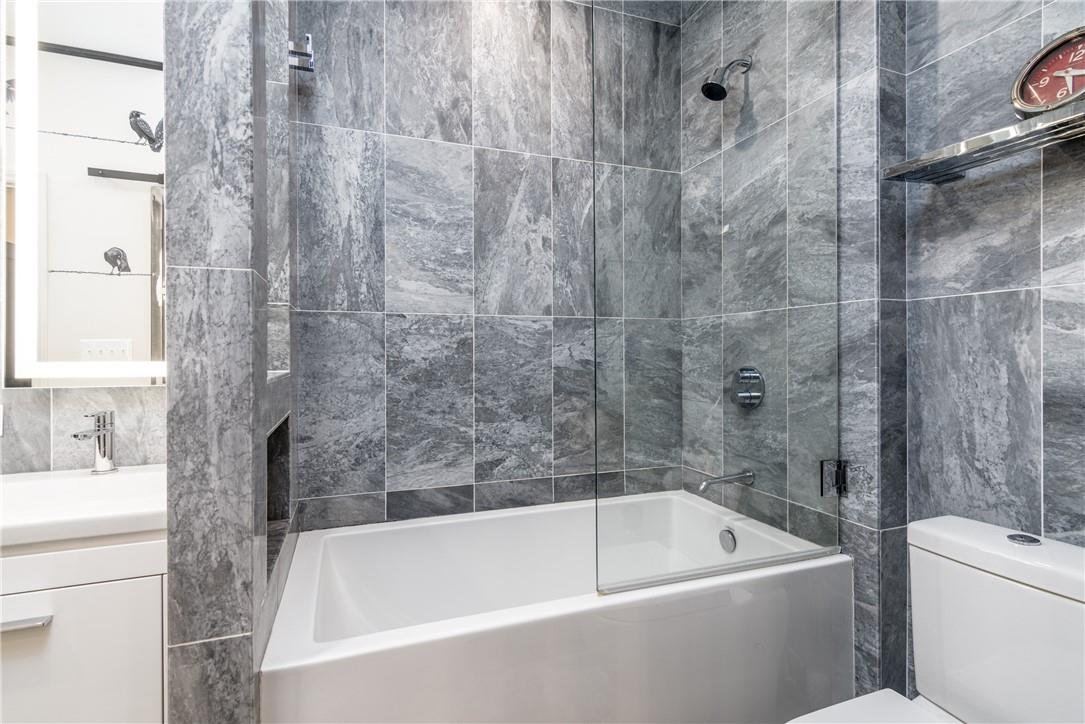 866 Cherokee Road Charlotte, NC 28207 - Photo 29 of 35 a bathroom with a white bath tub a toilet and a sink