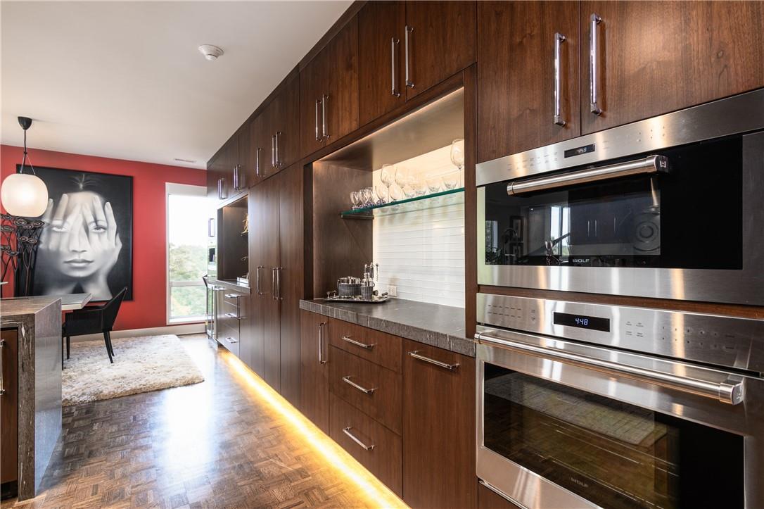866 Cherokee Road Charlotte, NC 28207 - Photo 5 of 35 a kitchen with stainless steel appliances and wooden cabinets
