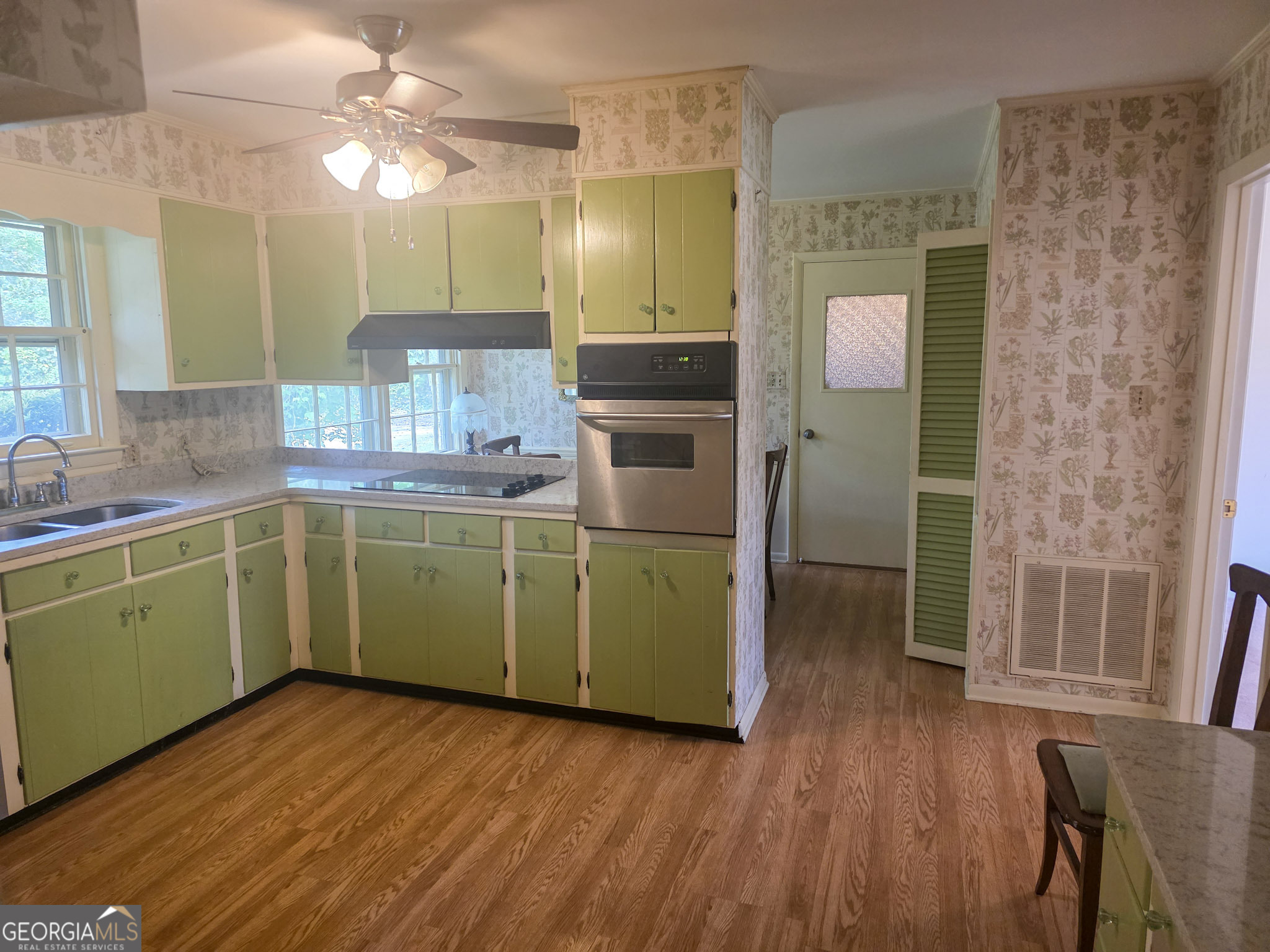 1712 Briarcliff Road Milledgeville, GA 31061 - Photo 13 of 44 a kitchen with a sink cabinets and wooden floor