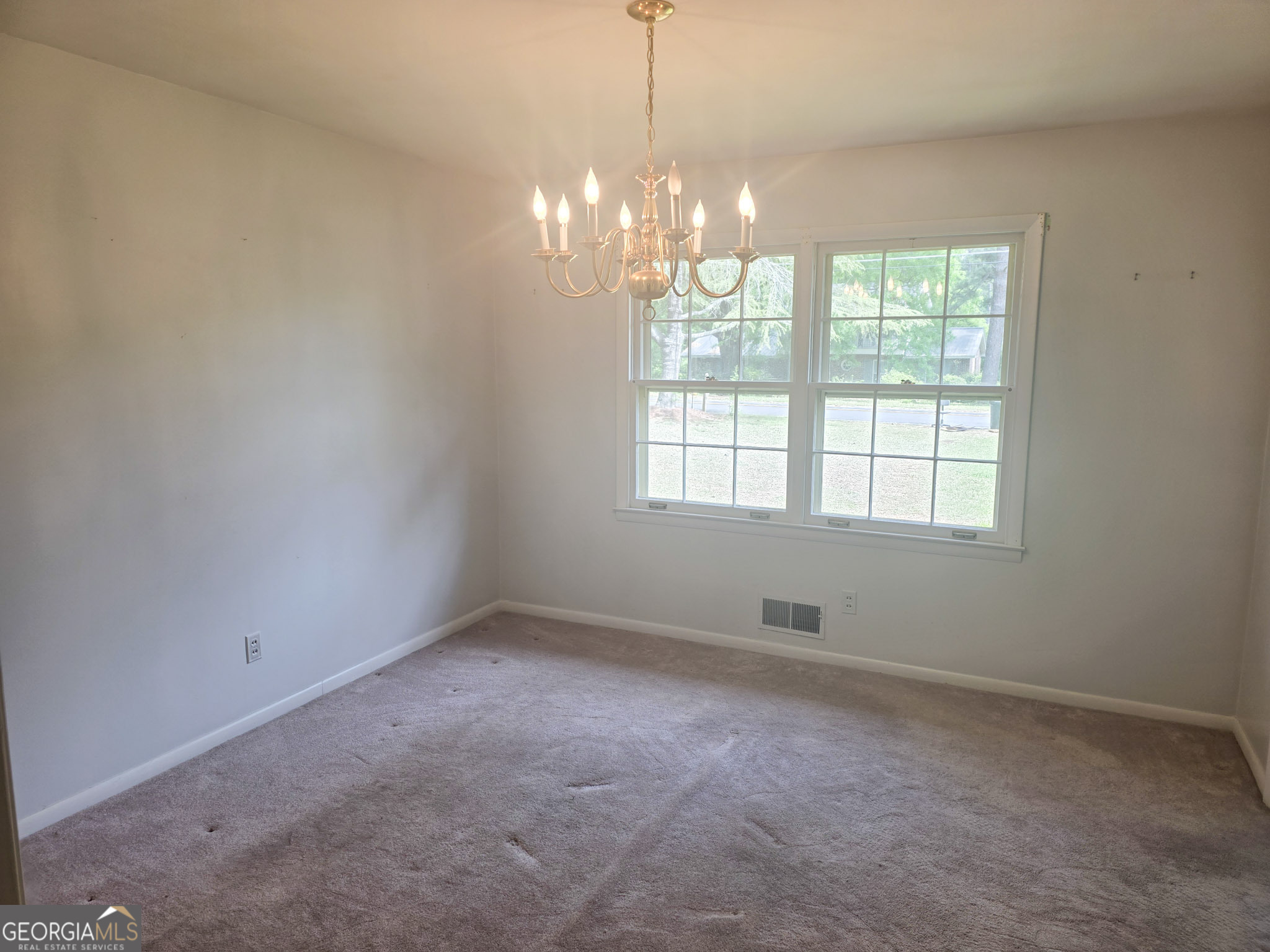1712 Briarcliff Road Milledgeville, GA 31061 - Photo 25 of 44 an empty room with windows and chandelier fan