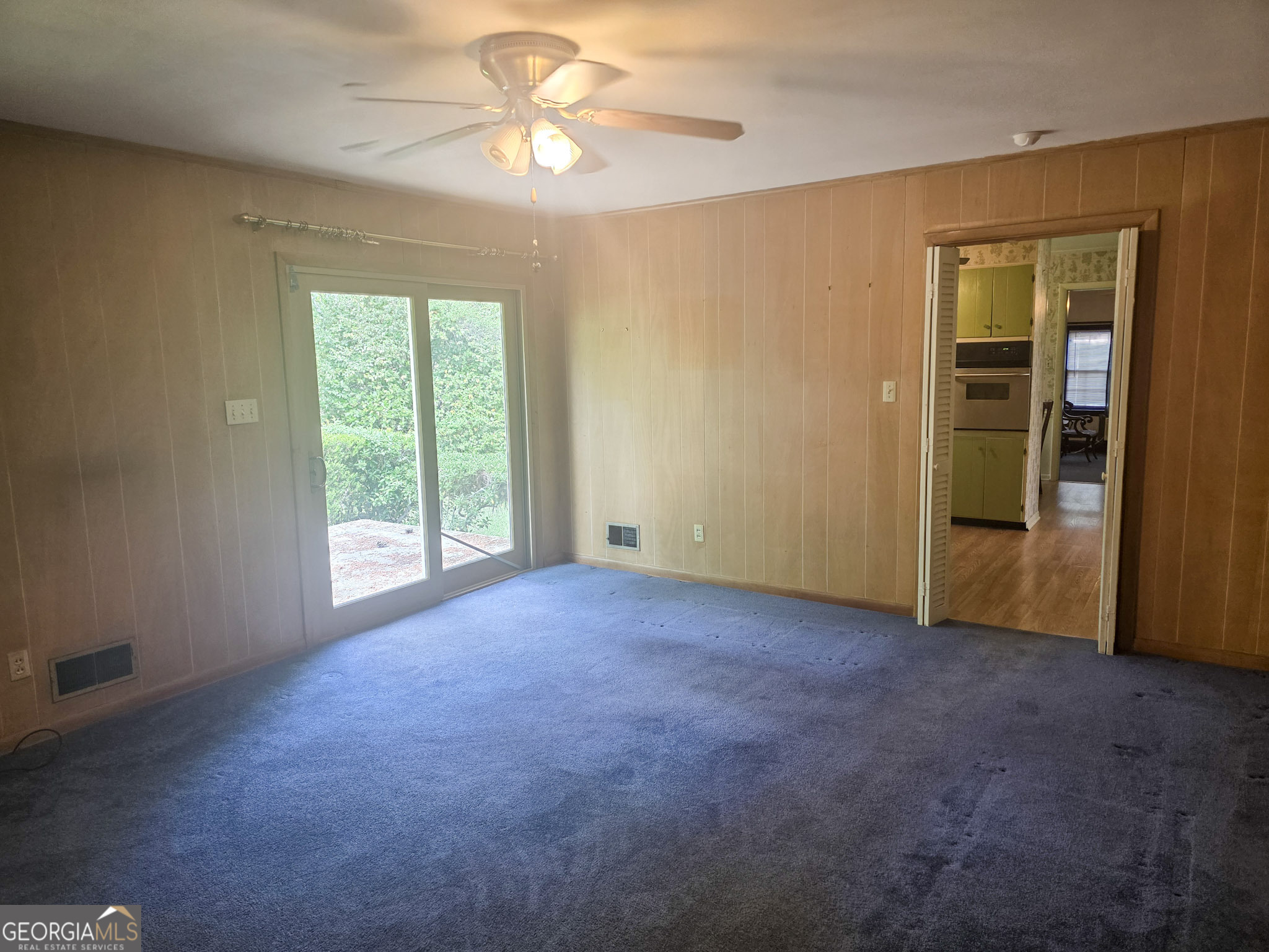 1712 Briarcliff Road Milledgeville, GA 31061 - Photo 29 of 44 an empty room with windows and a chandelier fan