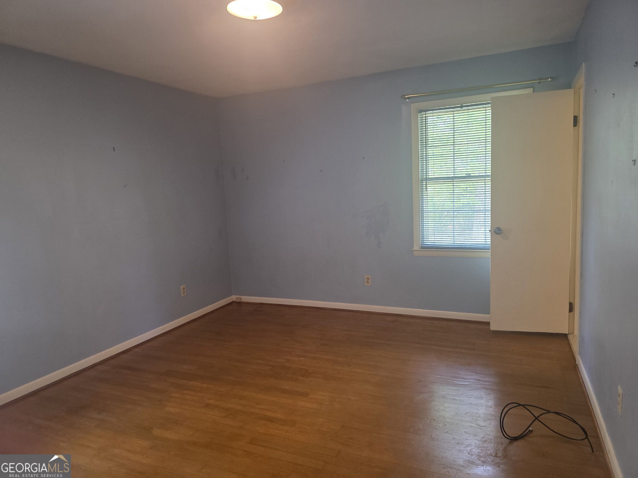 1712 Briarcliff Road Milledgeville, GA 31061 - Photo 37 of 44 an empty room with wooden floor and windows