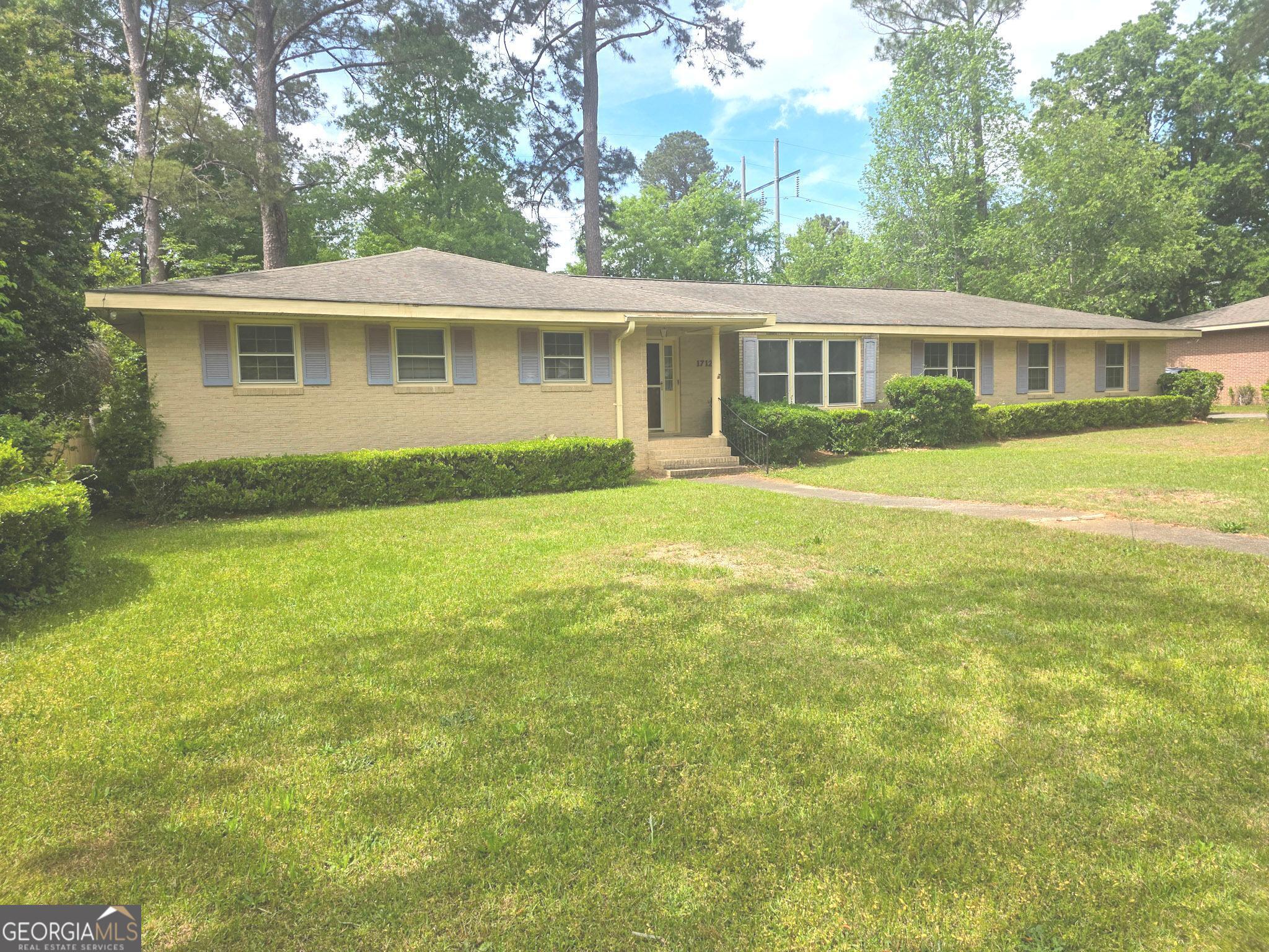 1712 Briarcliff Road Milledgeville, GA 31061 - Photo 6 of 44 a front view of a house with a garden