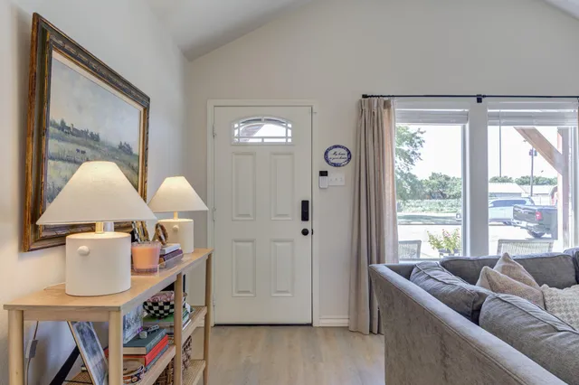 a living room with furniture a large window and a flat screen tv
