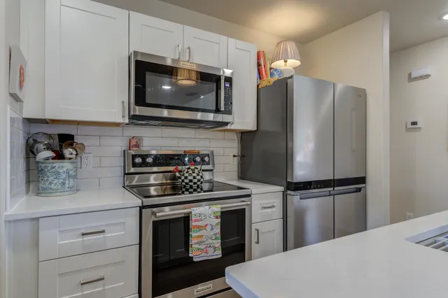 a kitchen with a refrigerator stove and microwave