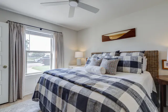 a bedroom with a large bed and a window