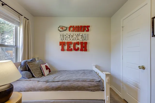 a bedroom with a bed and window