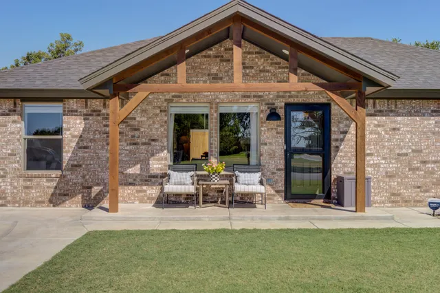 a view of a house with backyard porch and sitting area