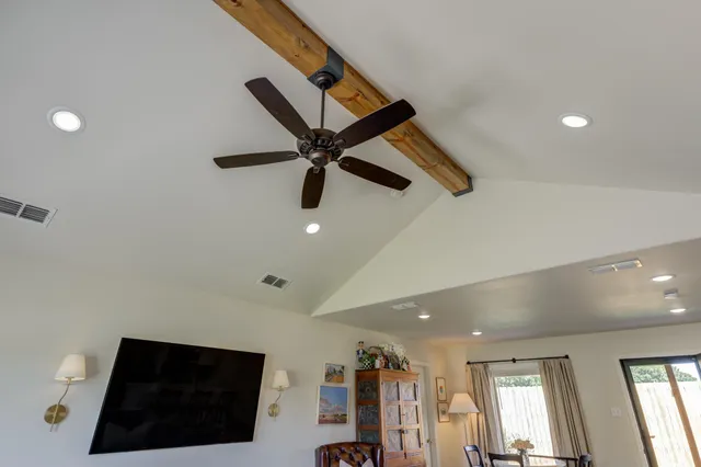 a view of a livingroom with a ceiling fan and wooden floor