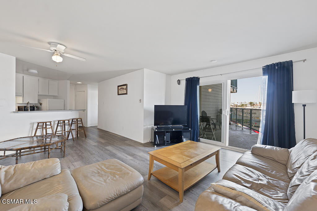 2901 Peninsula Road, Unit 137 Oxnard, CA 93035 - Photo 12 of 36 a living room with furniture a flat screen tv and a kitchen view
