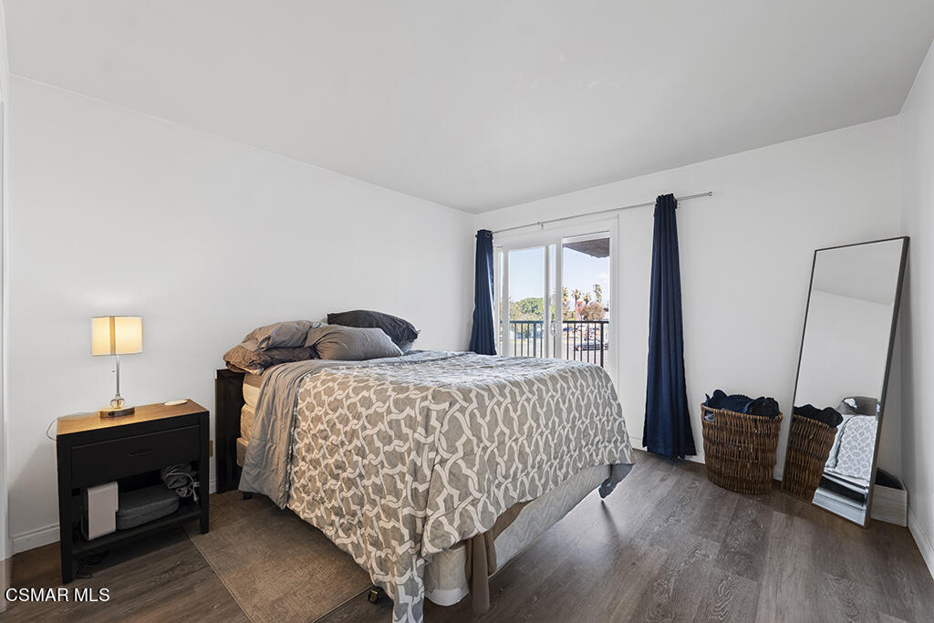 2901 Peninsula Road, Unit 137 Oxnard, CA 93035 - Photo 15 of 36 a bedroom with a bed and wooden floor