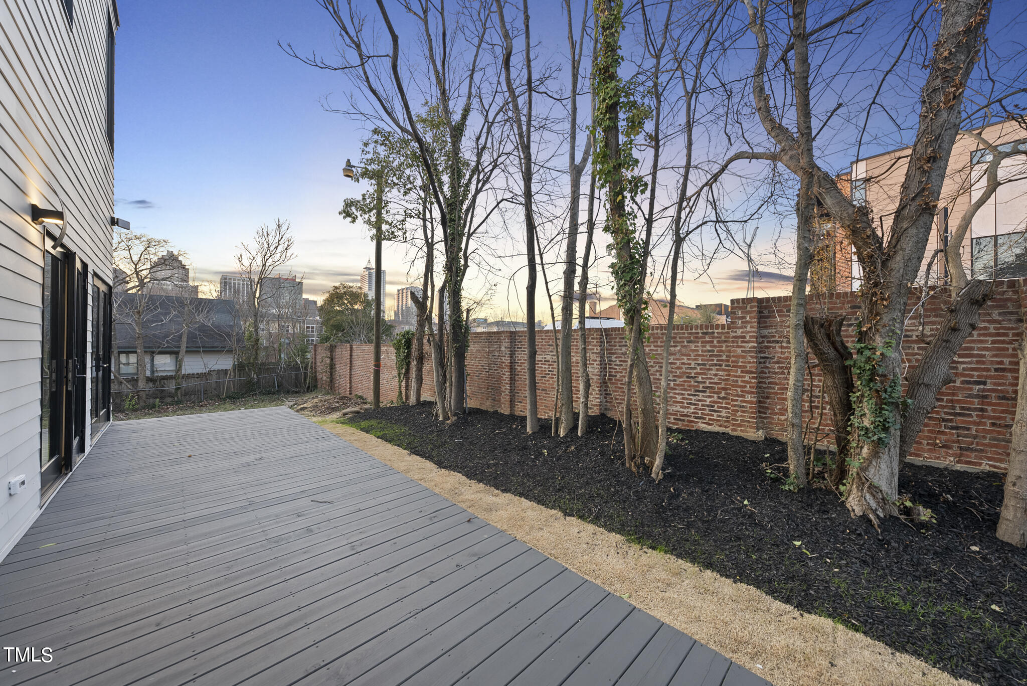 517 East Cabarrus Street Raleigh, NC 27601 - Photo 22 of 58 a street view with wooden fence and large trees