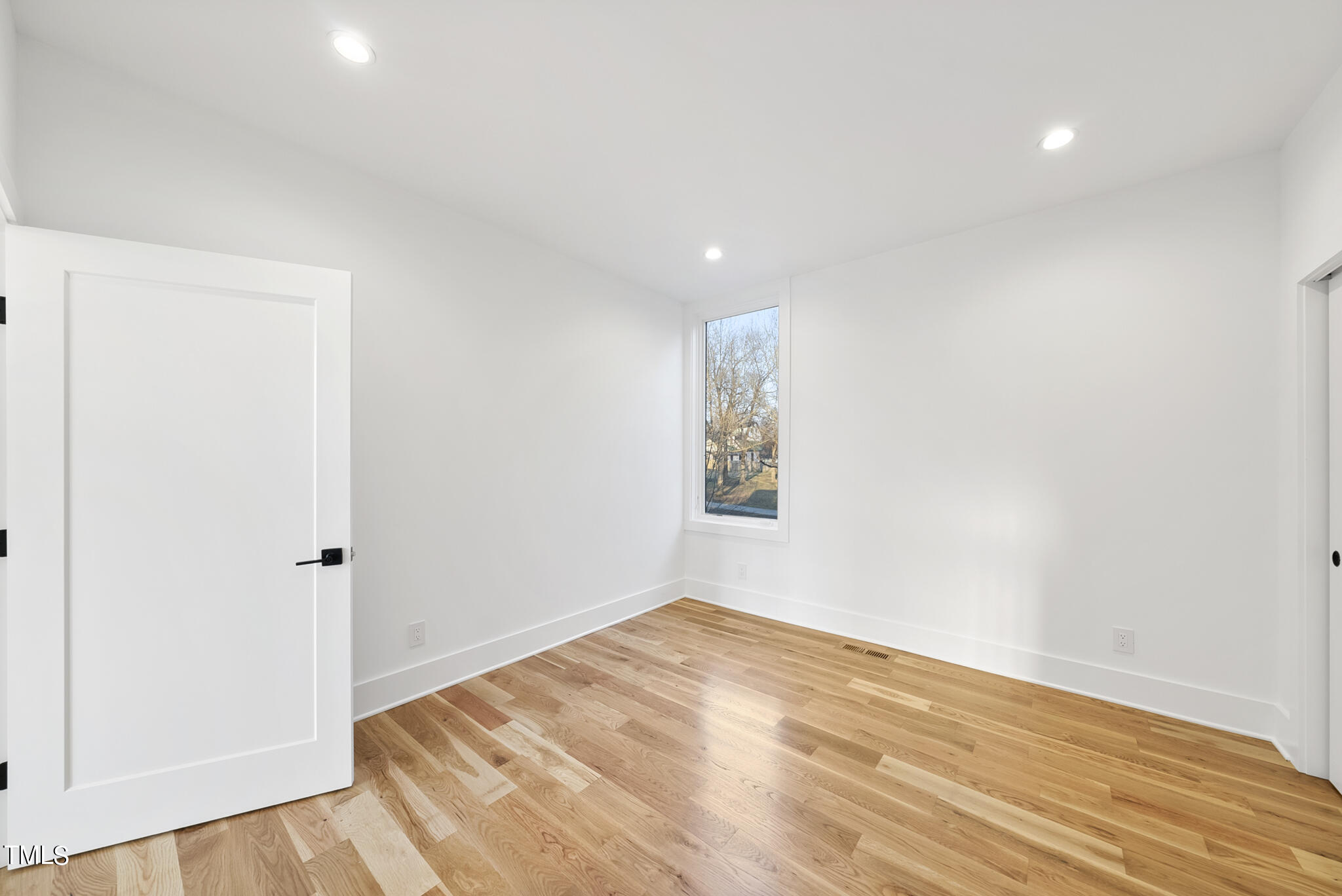 517 East Cabarrus Street Raleigh, NC 27601 - Photo 33 of 58 an empty room with wooden floor and window