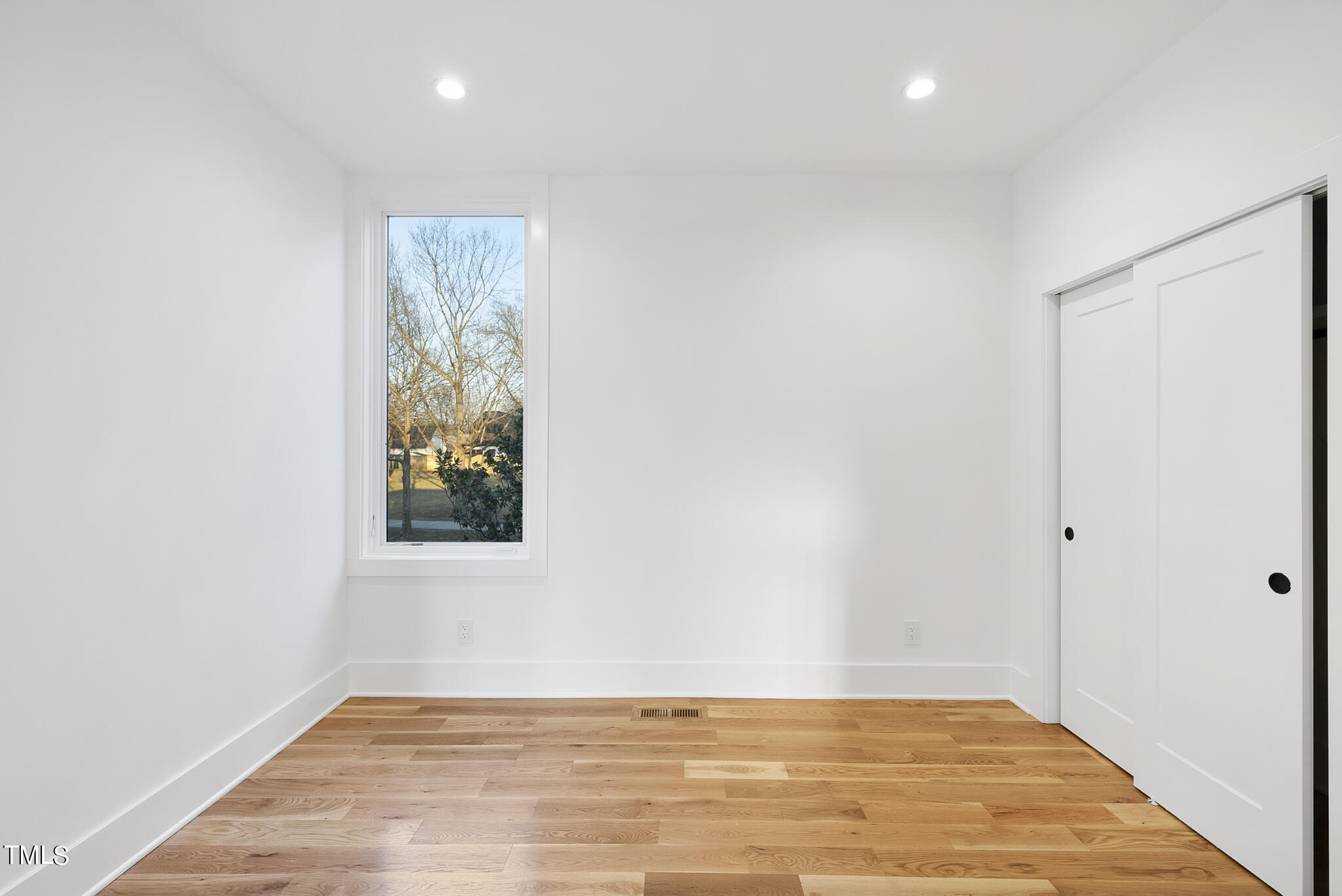 517 East Cabarrus Street Raleigh, NC 27601 - Photo 34 of 58 a view of an empty room with wooden floor and a window