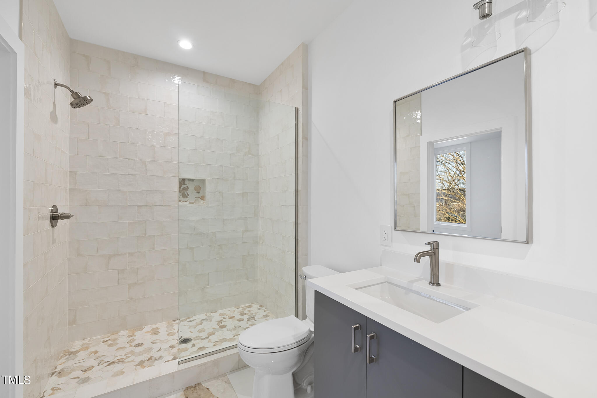 517 East Cabarrus Street Raleigh, NC 27601 - Photo 35 of 58 a bathroom with a sink a toilet and shower