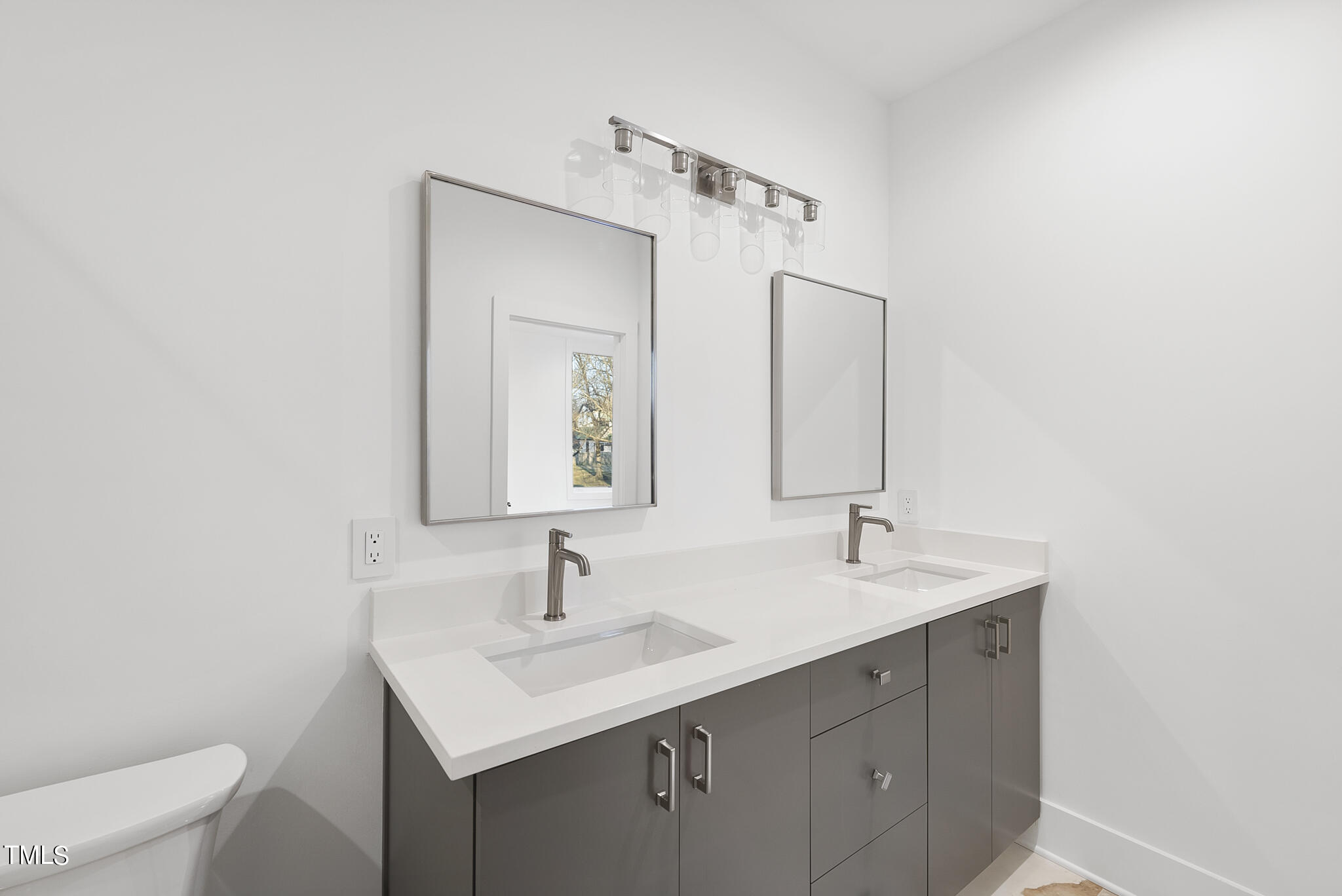 517 East Cabarrus Street Raleigh, NC 27601 - Photo 36 of 58 a bathroom with a toilet sink and mirror