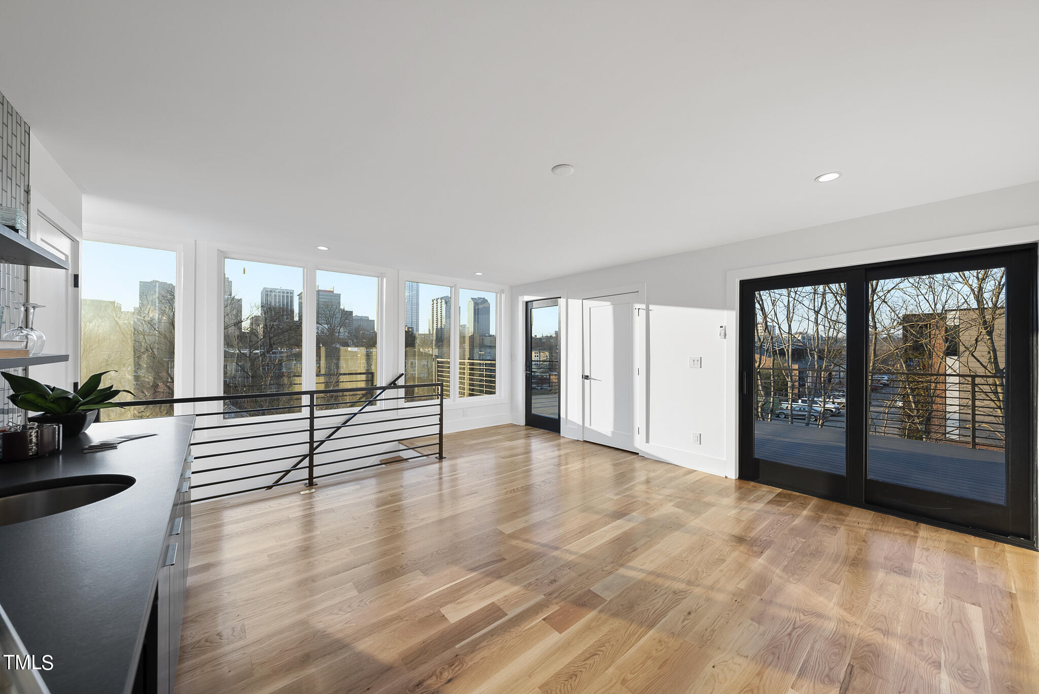 517 East Cabarrus Street Raleigh, NC 27601 - Photo 45 of 58 a view of empty room with wooden floor and floor to ceiling window