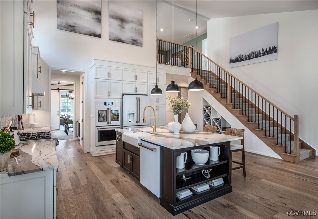 Undisclosed Address Chester, VA 23831 - Photo 2 of 41 Kitchen with white cabinetry, an island with sink,