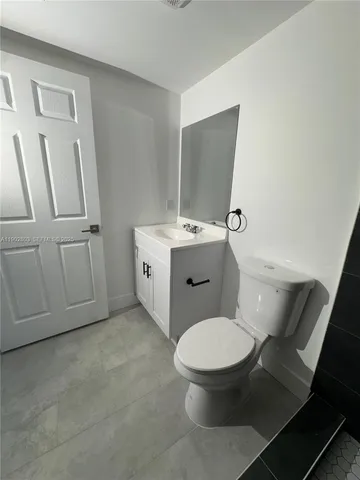 a bathroom with a toilet a sink and shower