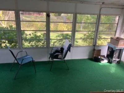 a living room with furniture and a floor to ceiling window