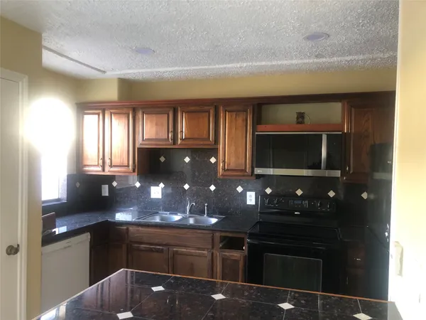 a kitchen with a sink and wooden cabinets