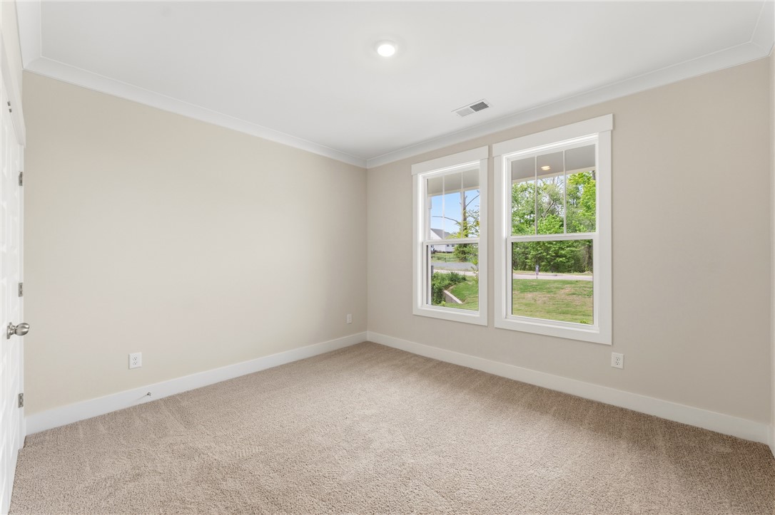 203 Timothy Court Anderson, SC 29621 - Photo 14 of 40 Comfortable carpeted space with bright windows, perfect for a peaceful retreat.